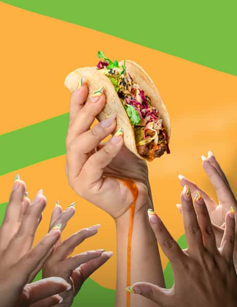 Someone holding a Lime Truck taco at an event