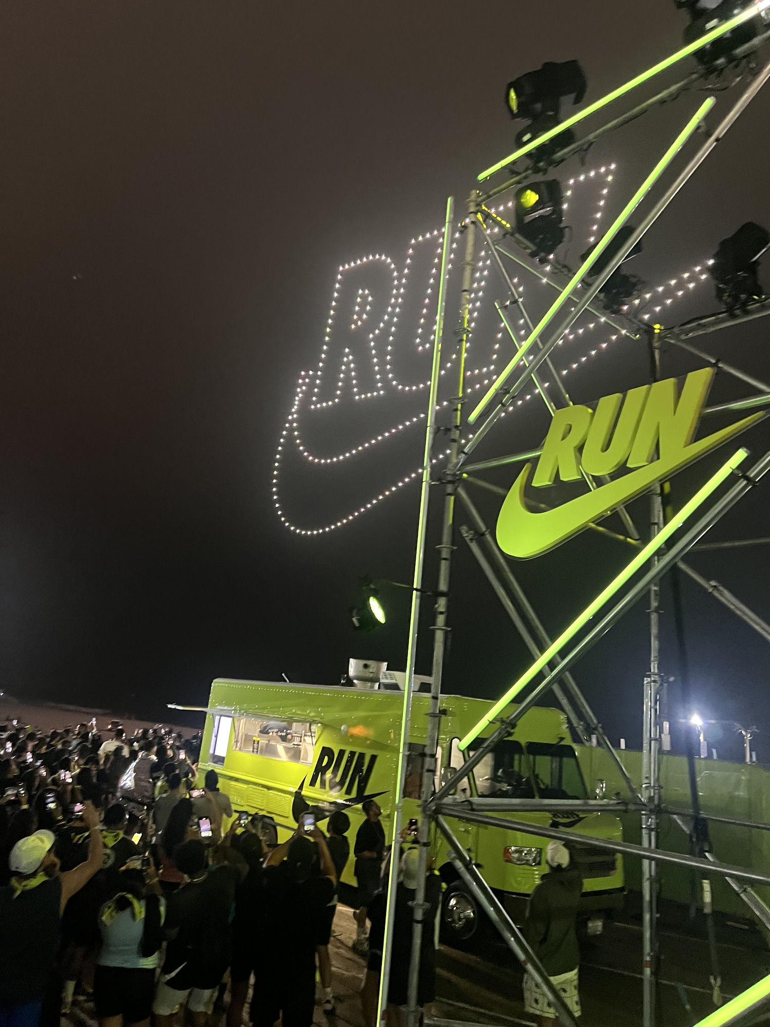 Nike RUN branded food truck wrap by The Lime Truck — neon truck anchoring drone light show